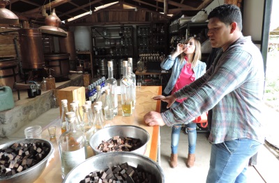 Malka enjoying a Cañazo tasting at the Caña Alta distillery in the Sacred Valley